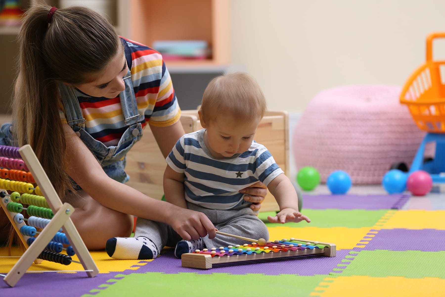 Teen,Nanny,And,Cute,Little,Baby,Playing,With,Xylophone,At